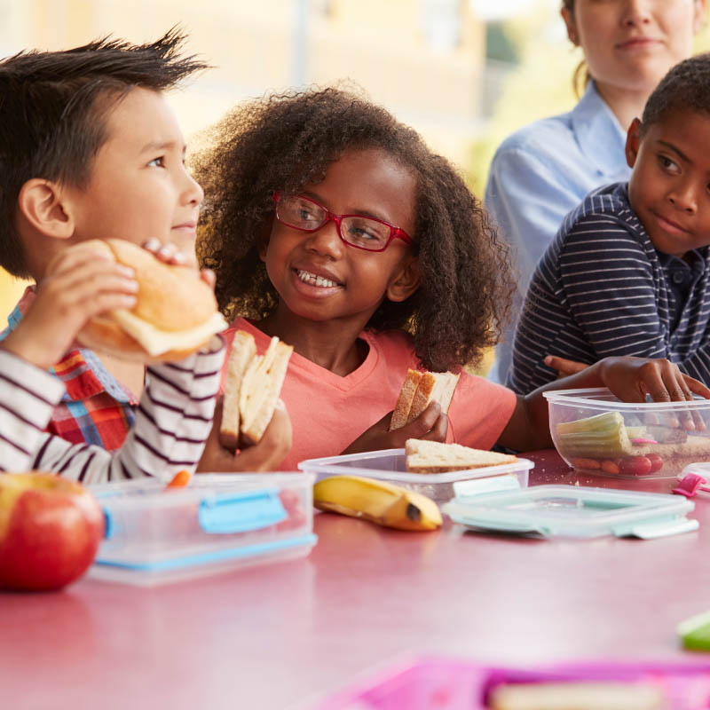 pre school kids eating packed lunches