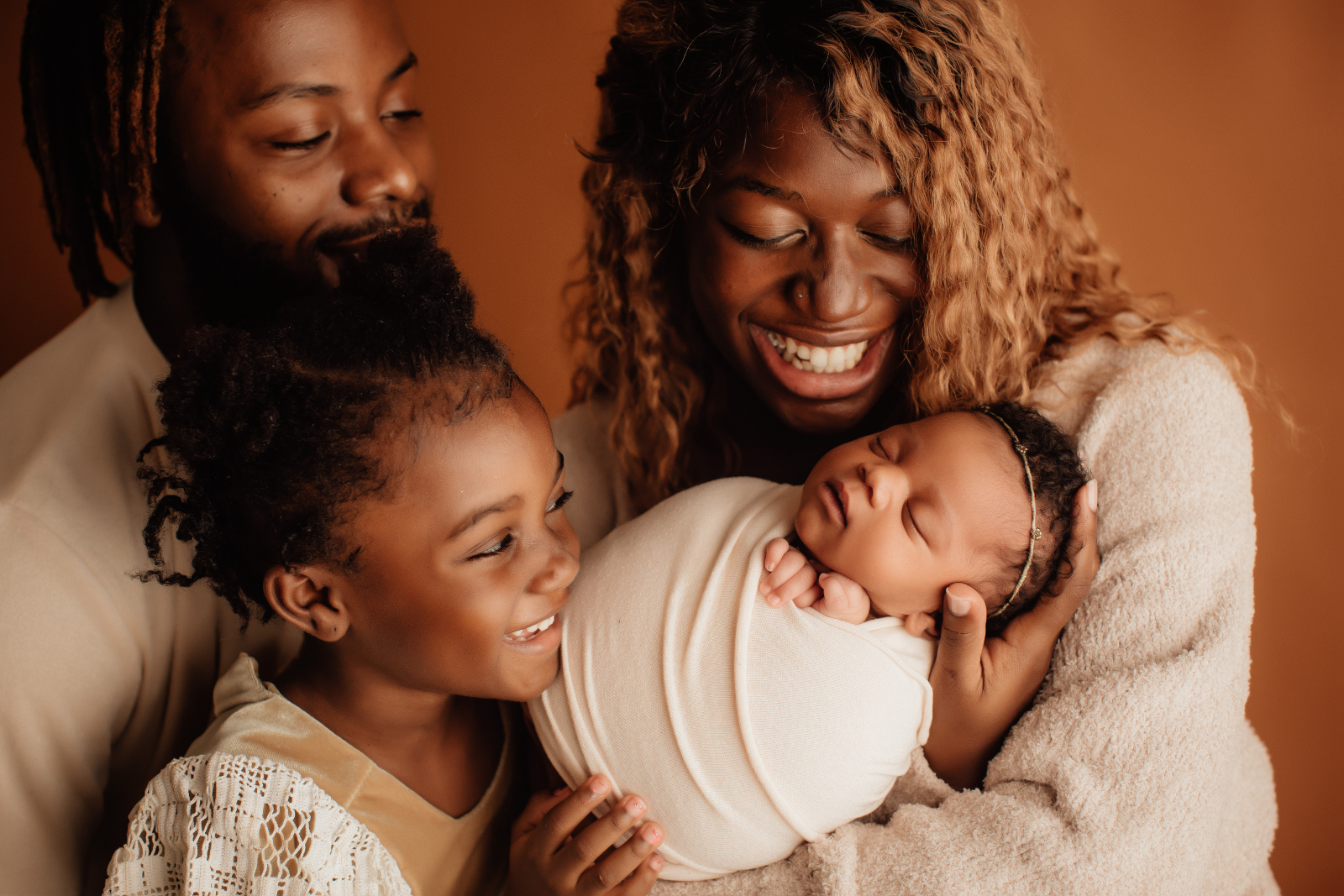 family with Mum, Dad, young daughter and new baby daughter