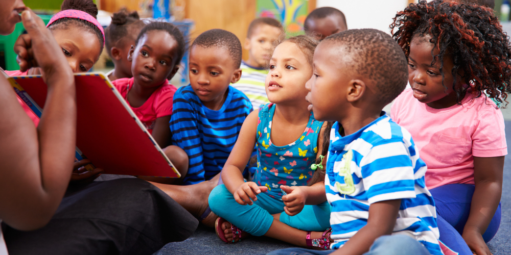 preschool kids looking at a book